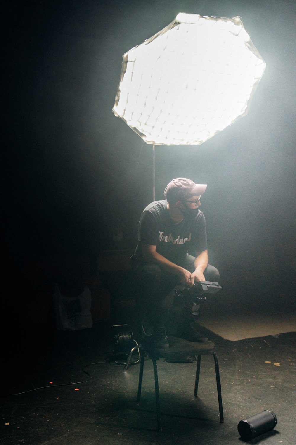 man in black crew neck t-shirt sitting on black chair