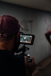man in black shirt holding black video camera