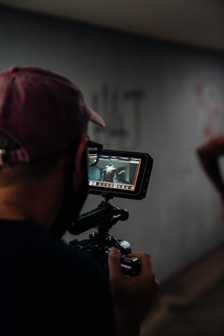 man in black shirt holding black video camera