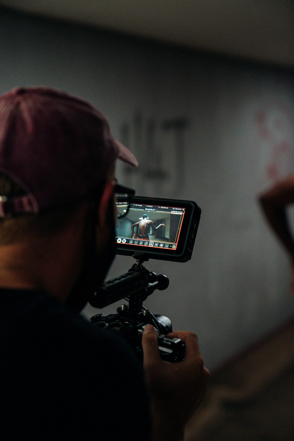 man in black shirt holding black video camera