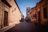 people walking on sidewalk near building during daytime