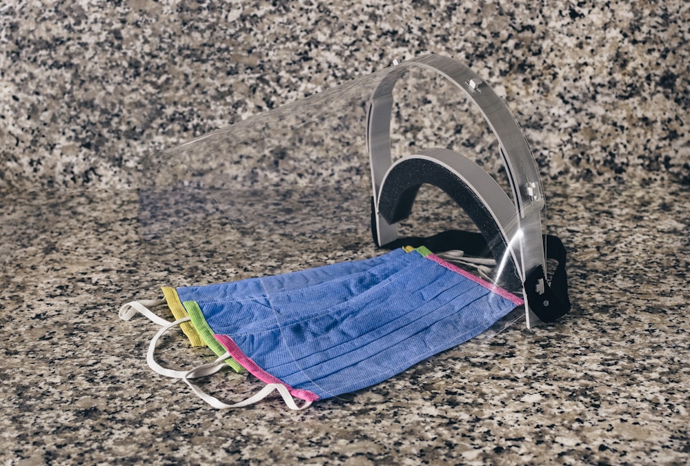 blue and white textile on brown and black marble table