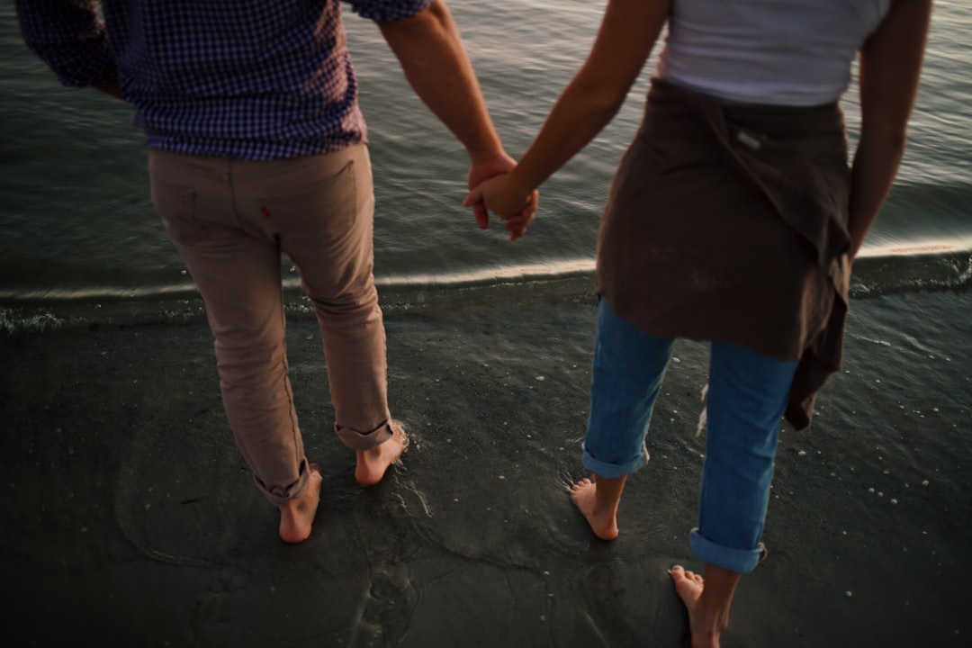 man in blue denim jeans standing beside woman in blue shirt