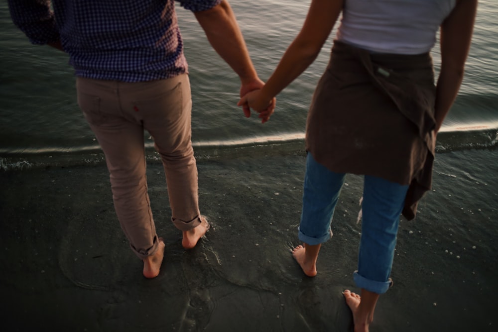 man in blue denim jeans standing beside woman in blue shirt