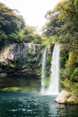 A picturesque waterfall cascading into a clear pool.