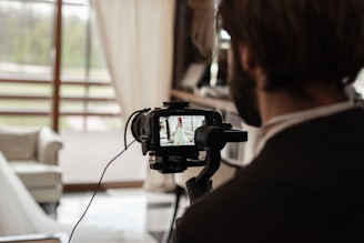 man in black shirt holding black camera