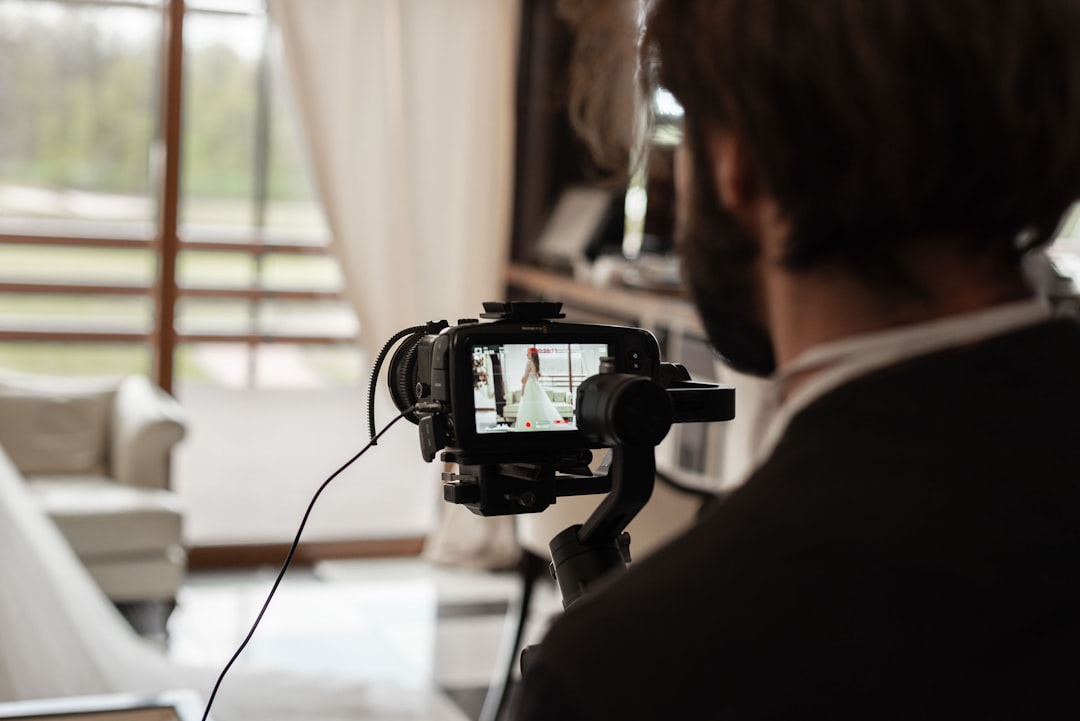 man in black shirt holding black camera