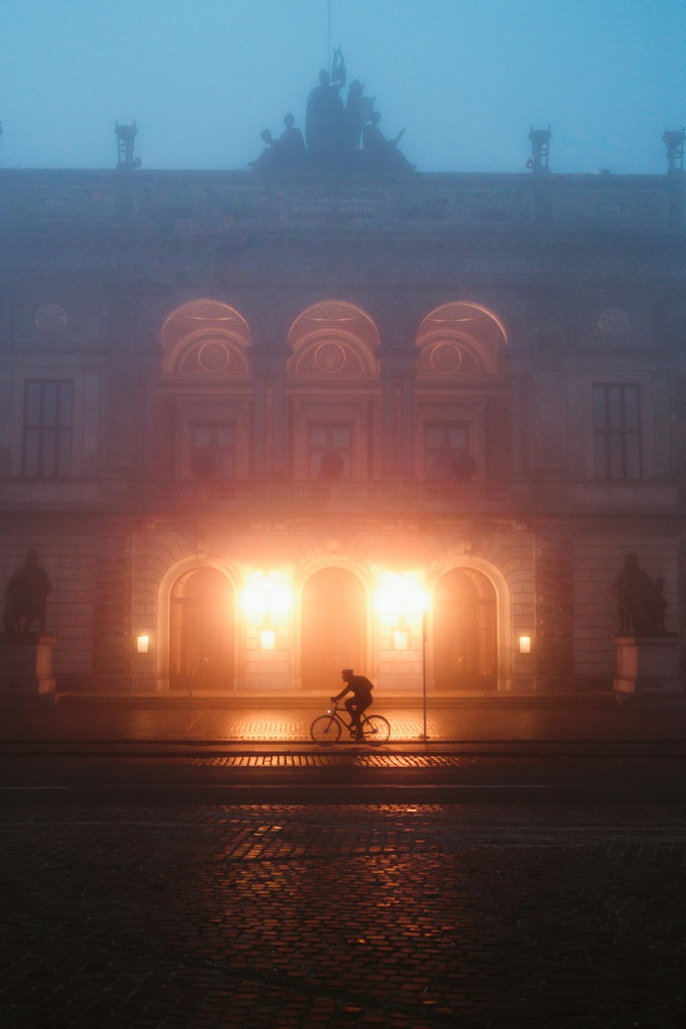 people walking near brown concrete building during night time