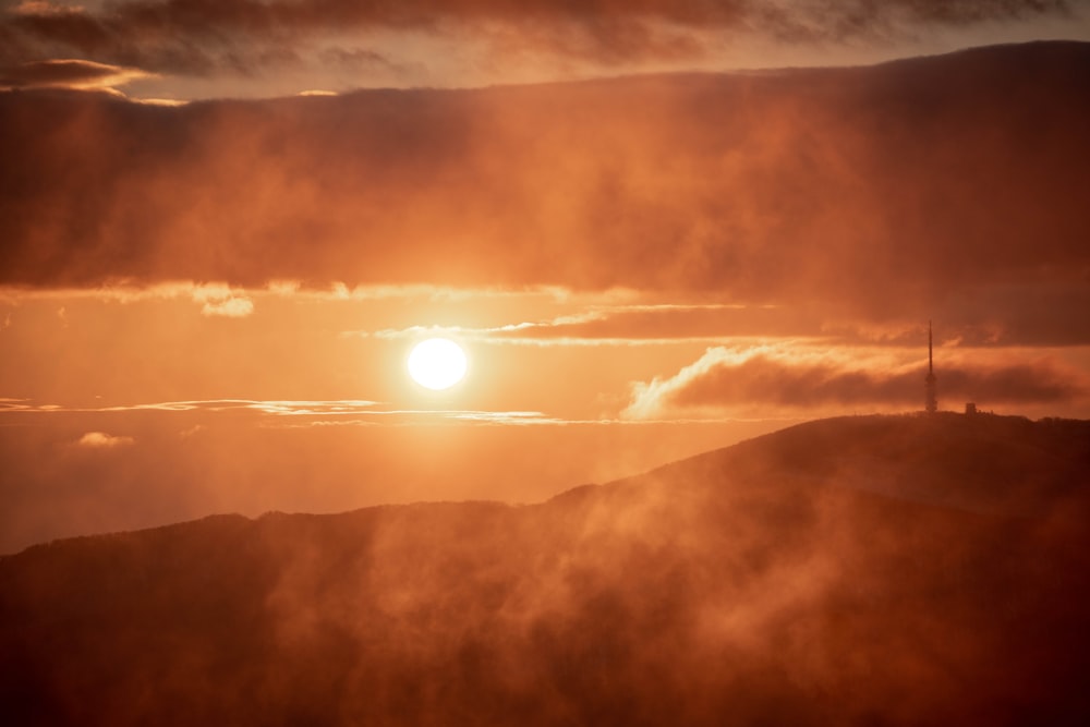 sun setting over the clouds