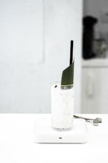 clear drinking glass with black straw