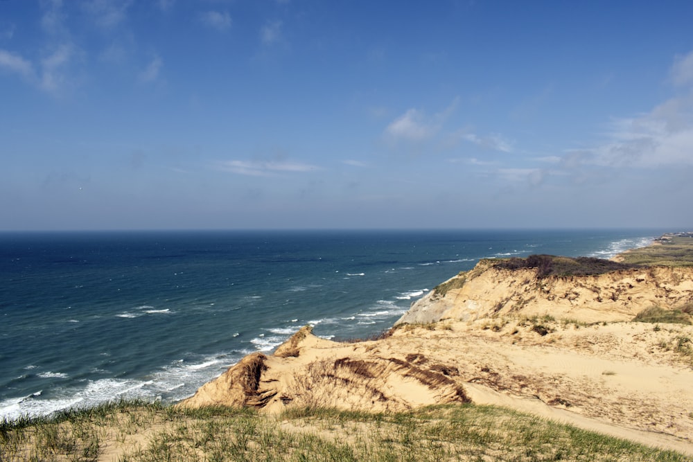 brown rock formation near body of water during daytime