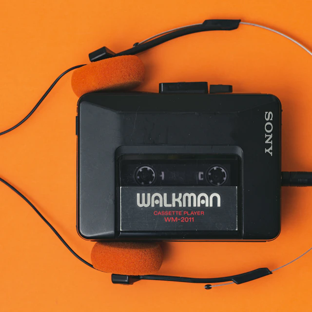 Vintage portable cassette player with a pair of headphones plugged into it
