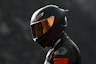 black and orange helmet on black motorcycle