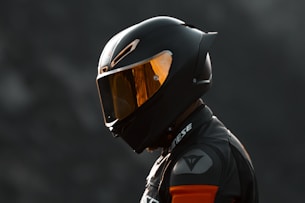 black and orange helmet on black motorcycle