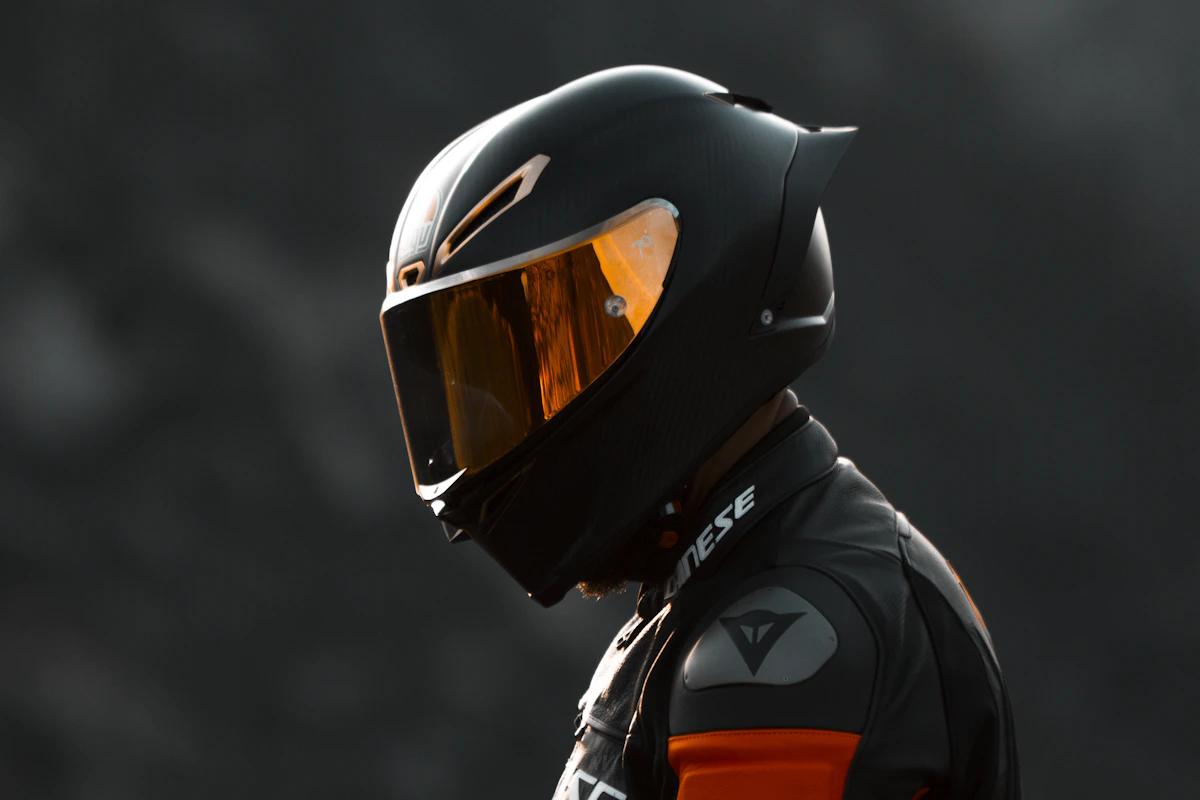 Motorcycle rider wearing a helmet and riding gear