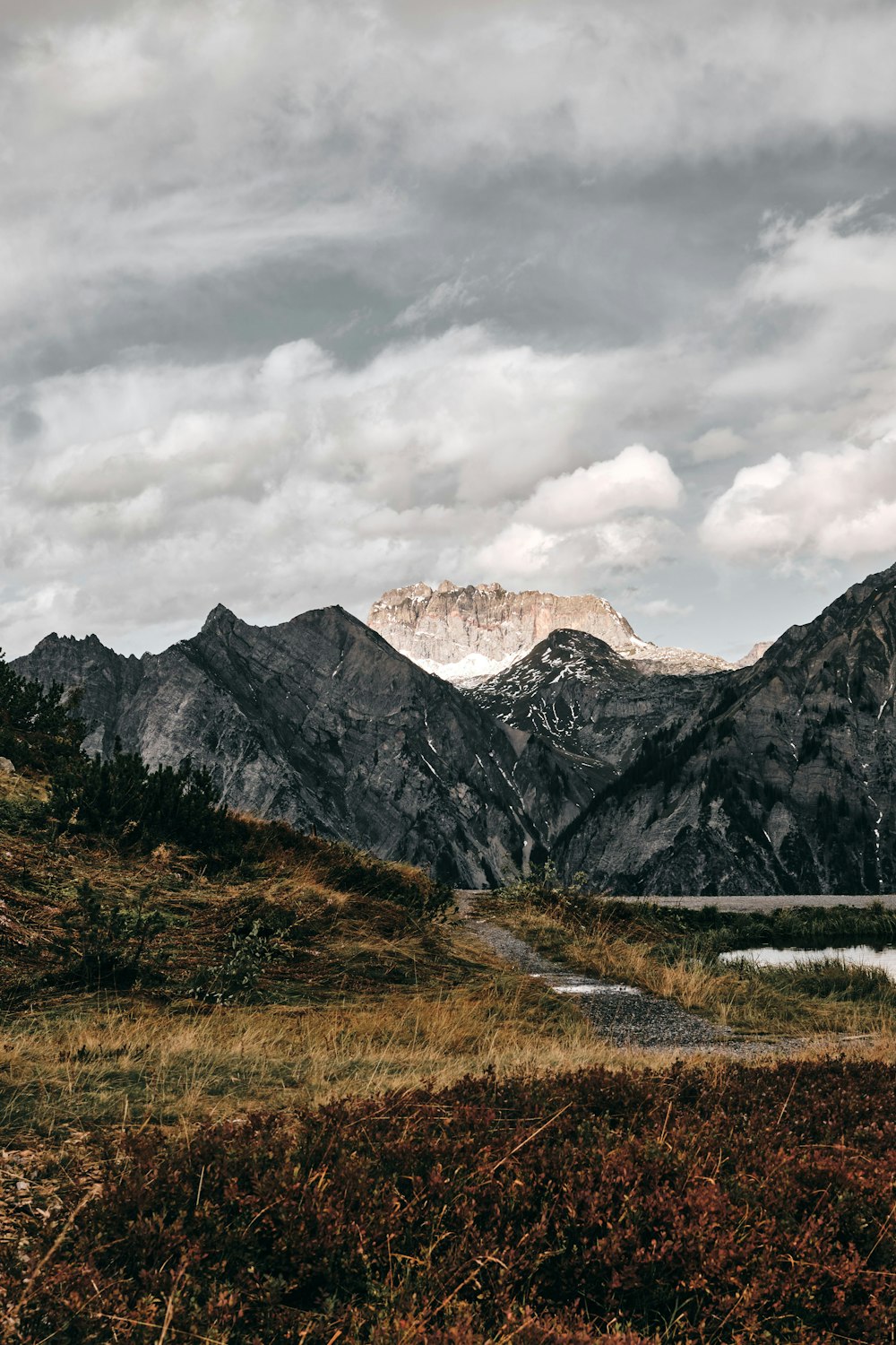 brown and white mountains under white clouds during daytime