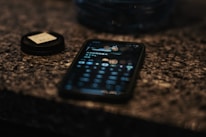 A close-up of a hand holding a phone showing a gentle reminder notification from Living Memory.