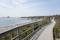 gray wooden fence near sea during daytime