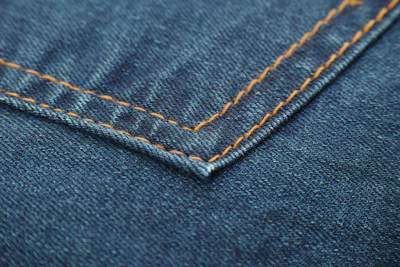 blue denim textile with white button