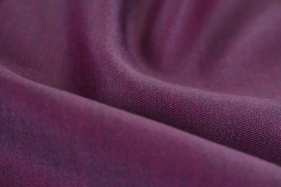 Close-up of soft, elegant fabric swatches in shades of lilac and purple.