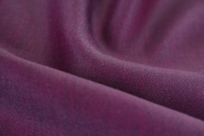 An elegant purple fabric draped with refined texture