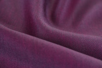 An elegant purple fabric draped with refined texture