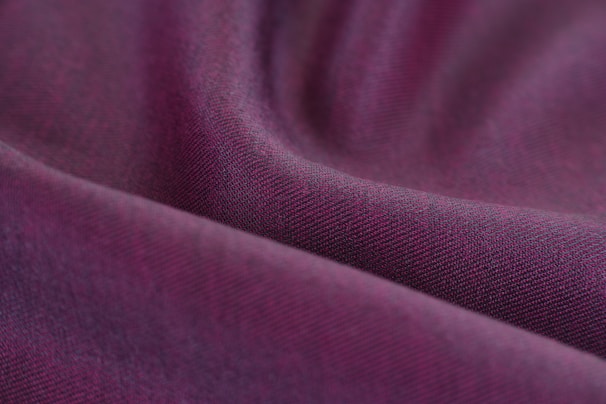 Close-up of vibrant purple fabric dyed with natural tannins, showcasing rich texture and color depth.