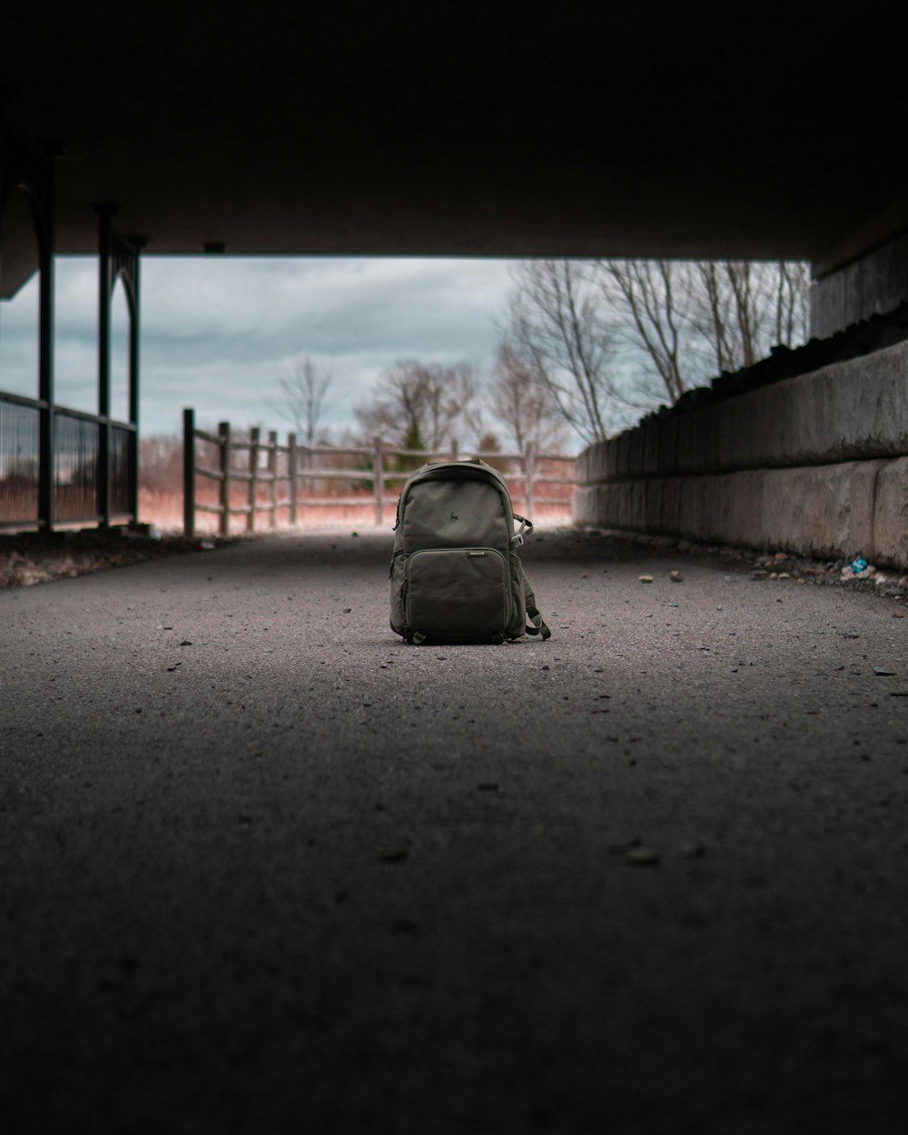 gray backpack on gray concrete road during daytime