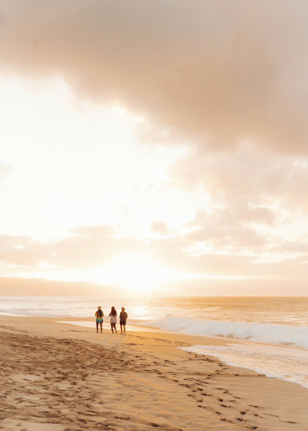 2 person walking on beach during daytime