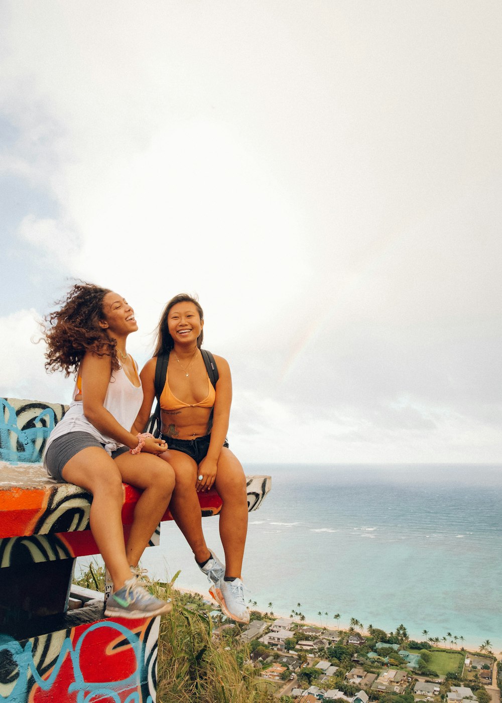 woman in black bikini sitting on orange and black chair