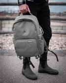 person in black jacket carrying gray backpack