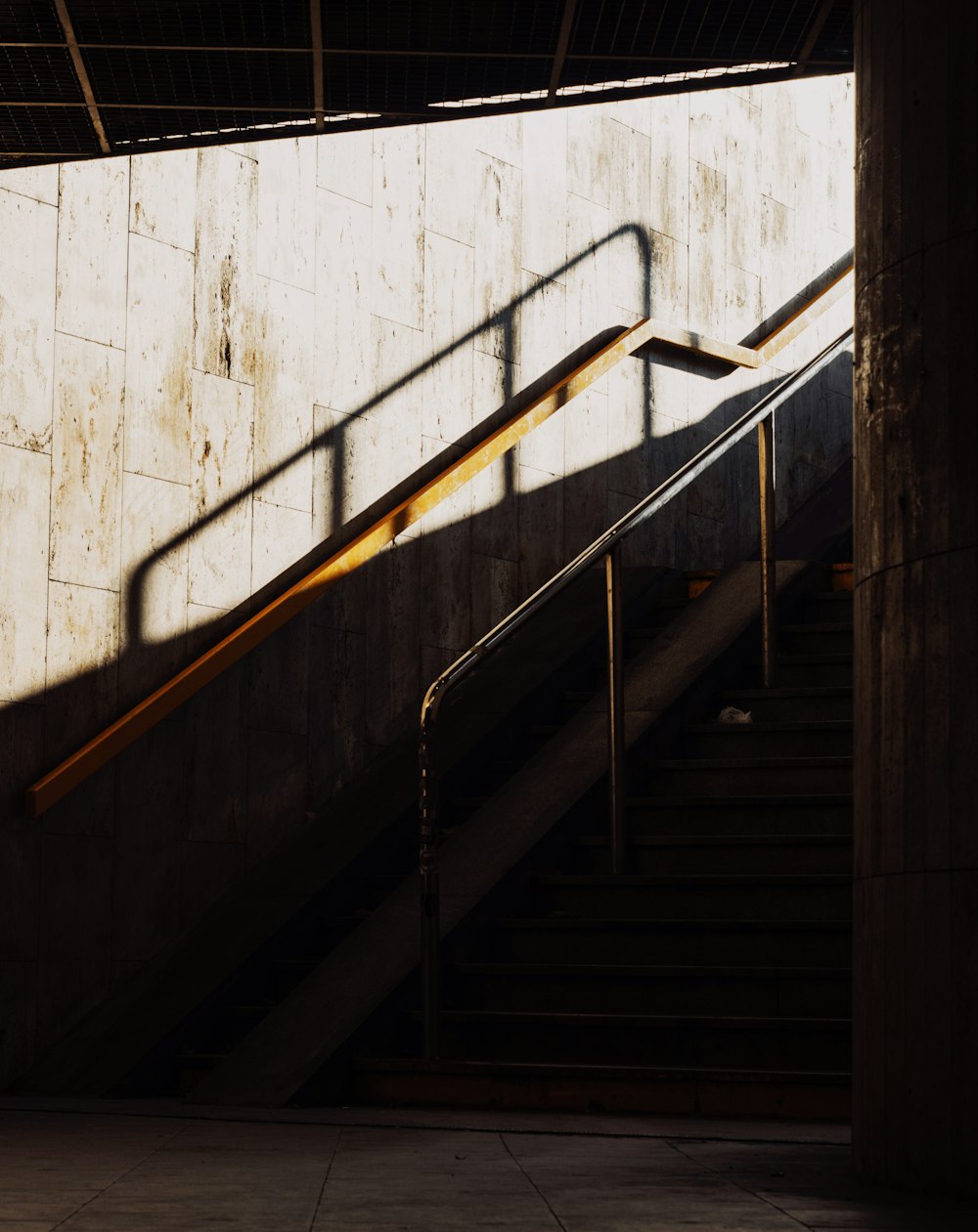 black metal staircase on white concrete wall