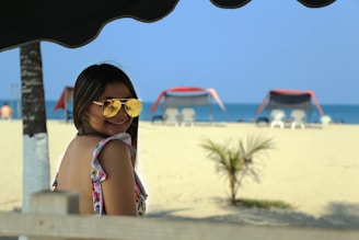 woman in pink and white polka dot bikini top wearing yellow sunglasses