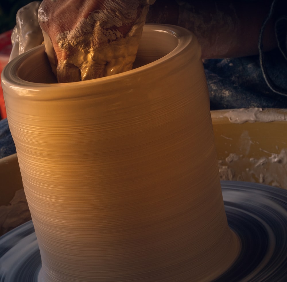 white round clay pot on white table