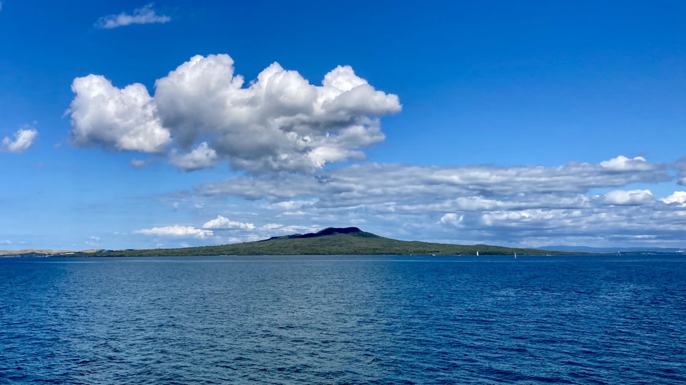 blue sea under blue sky and white clouds during daytime