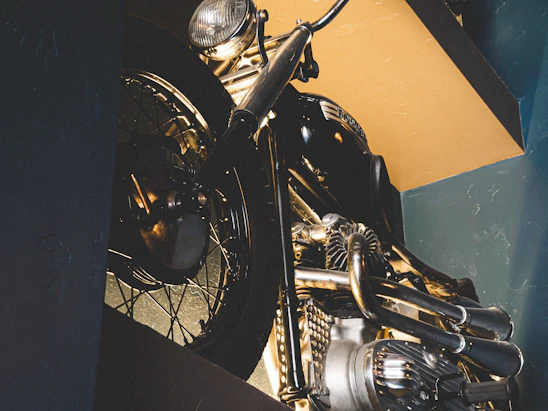 A striking close-up of a vintage Indian motorcycle gleaming under soft natural light, highlighting its intricate details.