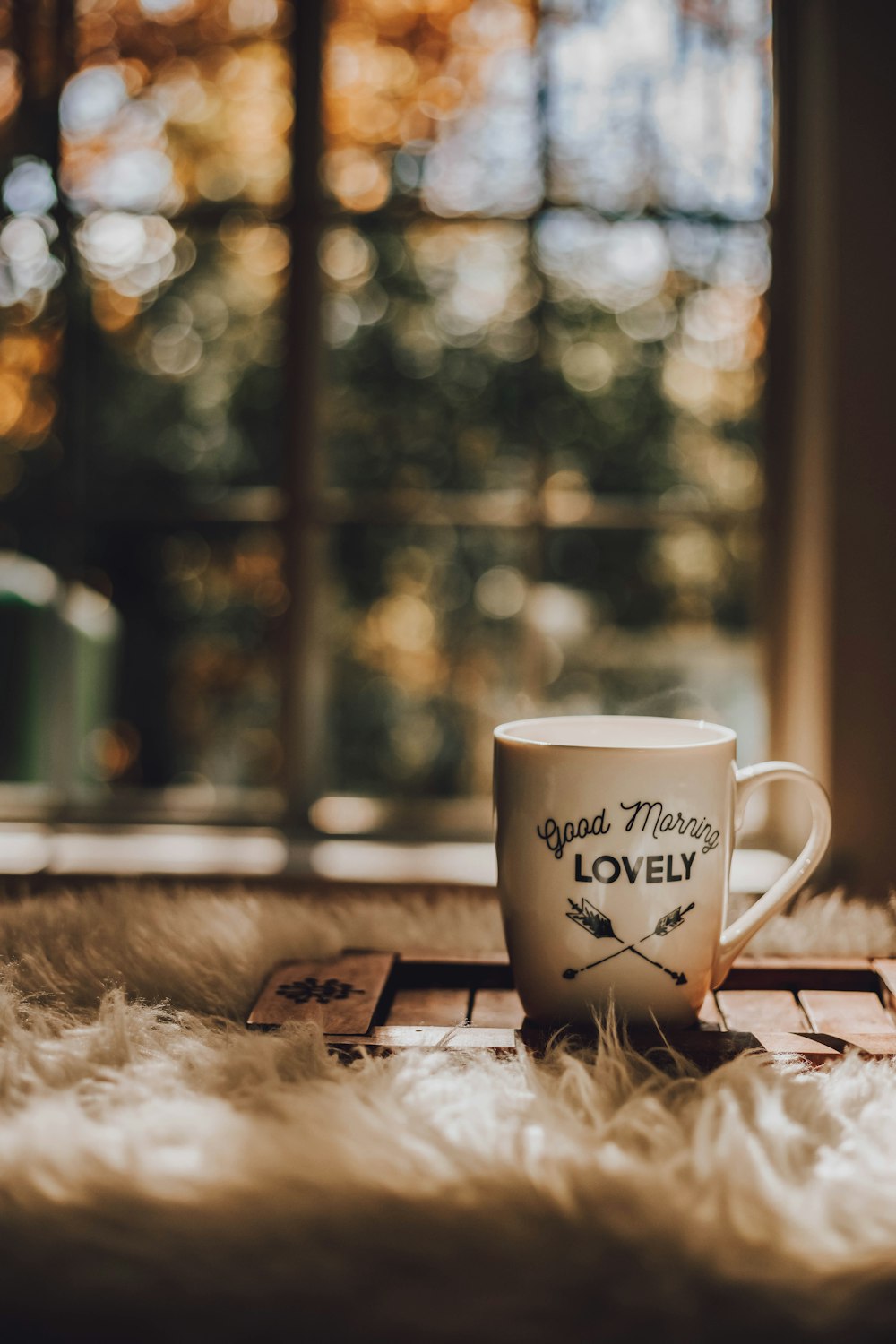 white ceramic mug on brown wooden coaster