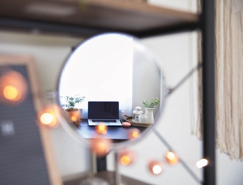 black and silver camera on glass mirror