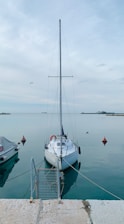 white sail boat on sea during daytime
