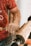 man in red and white nike crew neck t-shirt holding brown wooden rolling pin