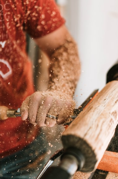 man in red and white nike crew neck t-shirt holding brown wooden rolling pin