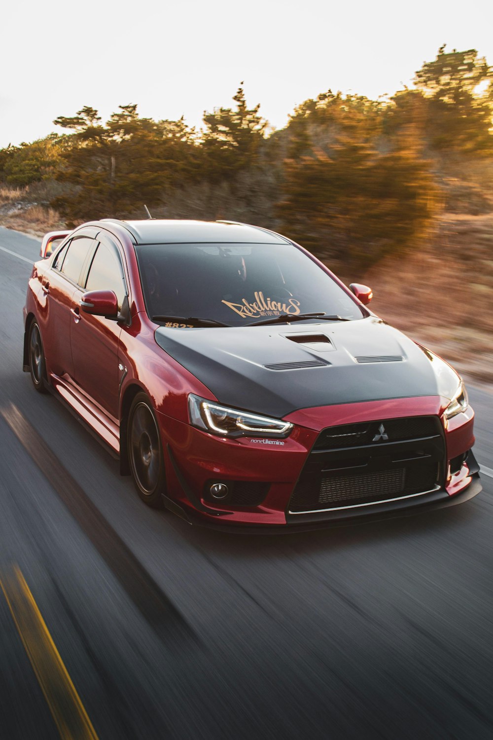 red honda sedan on road during daytime