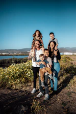 A family in Ensenada with two adults holding four children in a field