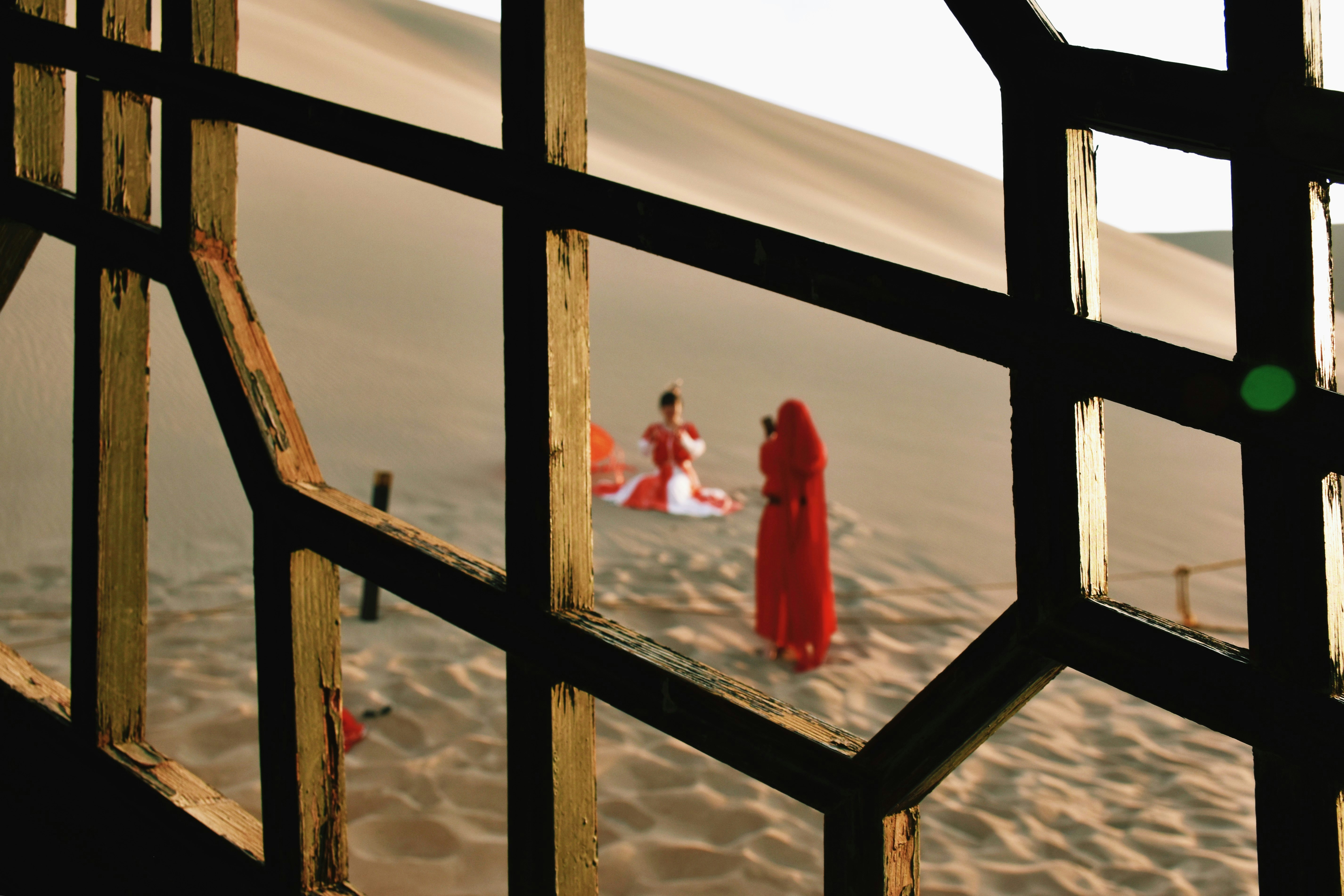 2 women in red dress standing on snow covered ground during daytime