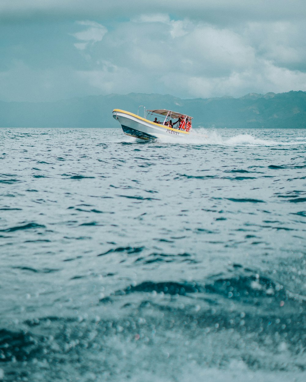 white and red boat on sea during daytime