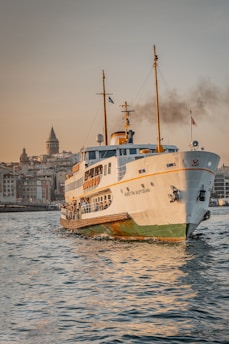 white and yellow ship on water near buildings during daytime