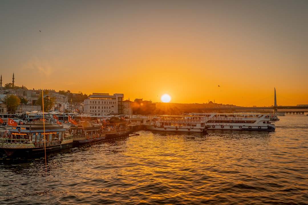 body of water near city buildings during sunset