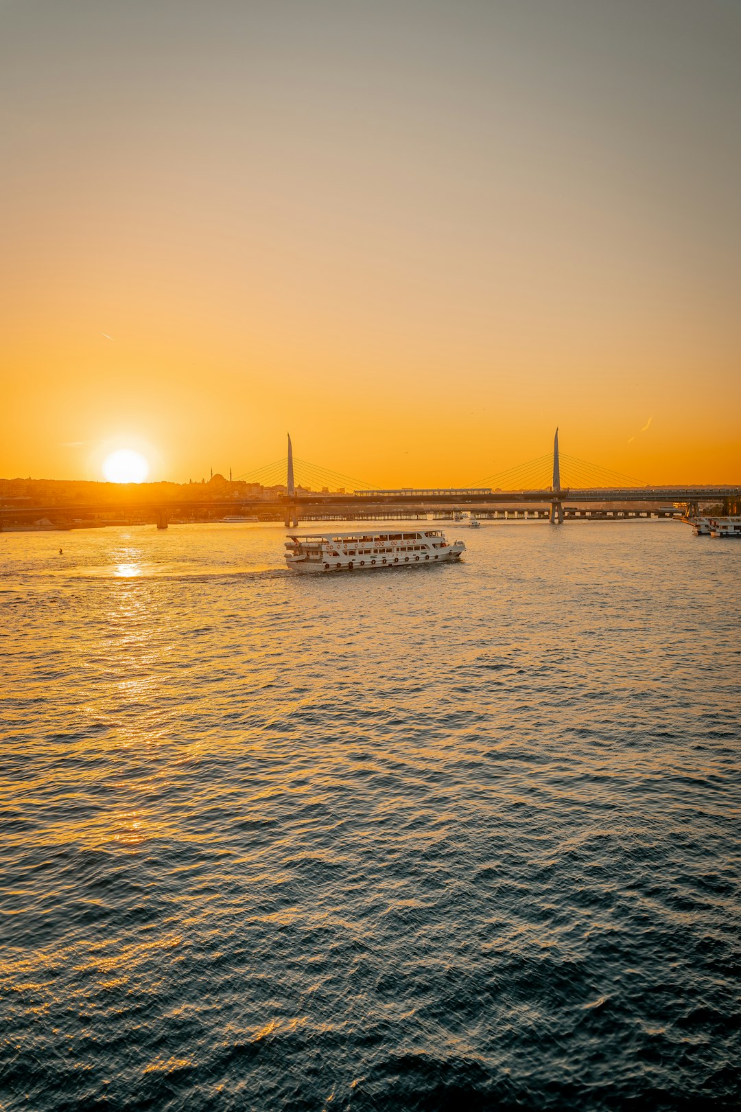 white boat on sea during sunset