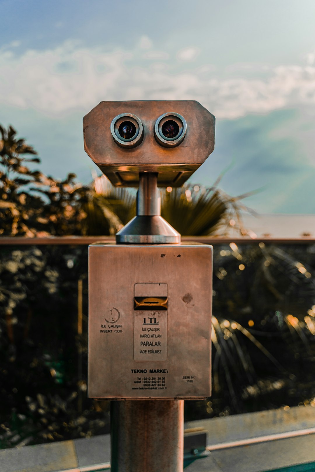 brown and black coin operated binoculars