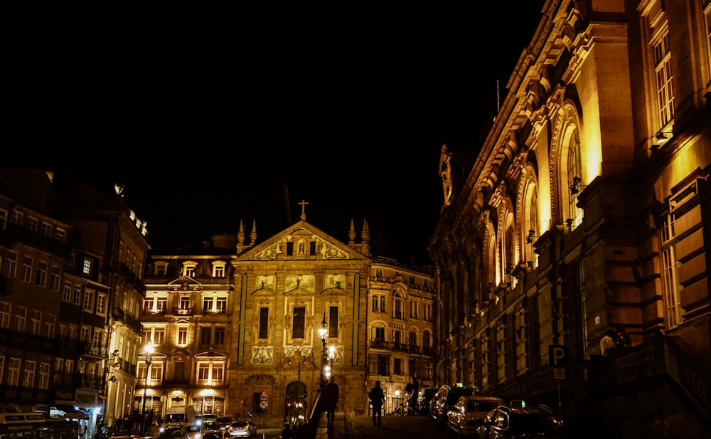 people walking near brown concrete building during nighttime